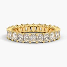 a yellow gold ring with baguetts and diamonds