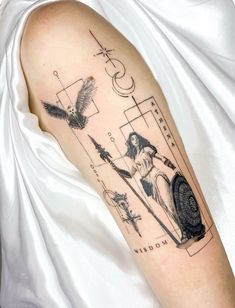 a woman's arm with tattoos on it and an image of a bird in the background