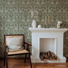 a white fireplace in a living room next to a chair