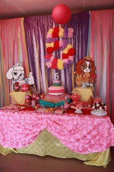 the table is decorated with pink, yellow and red decorations