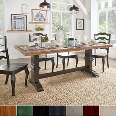 a dining room table with chairs and pictures on the wall above it, along with color swatches