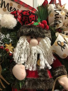 a close up of a christmas decoration with santa clause on it's head and beard