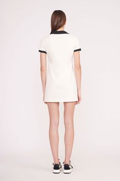 Cotton pique polo dress with short sleeves and a v-neck. The Volley Dress offers a relaxed silhouette and contrast collar and sleeve bindings. Chic Short Sleeve Dress With Striped Collar, Fitted Short Sleeve Dress With Striped Collar, Classic White V-neck Shirt Dress, Casual Short Sleeve Dresses With Striped Collar, White Chic Dress With Contrast Trim, Summer Dress With Striped Collar And Short Sleeves, Classic Summer Dress With Striped Collar, White Short Sleeve Tennis Dress, Classic White Mini Dress With Short Sleeves