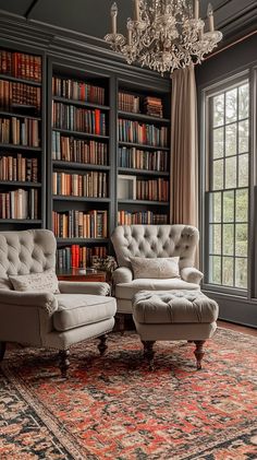 two chairs and a ottoman in front of a bookshelf