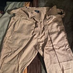 I Have Never Worn These, I Have Tried But They Are Not My Style They Have Been Sitting Folded In A Drawer Somewhere And That Is Why They Are So Wrinkly! Just Want Them To Go To A Good Home! Casual Spring Cargo Pants With Paperbag Waist, Casual Khaki Paperbag Waist Bottoms, Casual Beige Pants With Tie Waist, Casual Khaki Paperbag Waist Pants, Casual Paperbag Waist Khaki Pants, Casual High-waisted Jumpsuits And Rompers For Day Out, Casual Beige High Waist Jumpsuit, Casual High-waisted Jumpsuits For Day Out, Casual High Waist Jumpsuits And Rompers