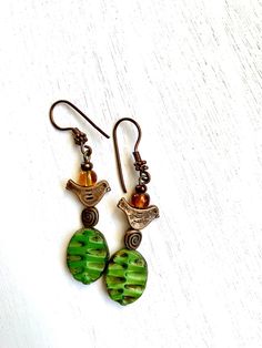 Green Orange Boho Earrings, Dangle Earthy Earrings, Orange drop Jewelry, Boho Jewelry, Burnt Orange Earrings, Copper Jewelry, Gift for mom, vintage look  Czech glass earrings featuring adorable little copper two-sided birds dangling from green Czech glass. Handmade beaded drop earrings, boho handmade made with Czech glass beads and copper findings. Length is 2.75 inches from copper ear wire Free shipping with USPS, packed and protected in a beautiful gift . Pierced Green Copper Earrings, Adjustable Green Drop Plug Earrings, Green Copper Pierced Earrings, Green Copper Earrings With Ear Wire, Green Copper Earrings, Earthy Earrings, Drop Jewelry, Boho Handmade, Orange Earrings