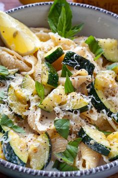 pasta with zucchini, spinach and parmesan cheese in a bowl