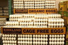 eggs are stacked on top of each other in boxes for sale at a grocery store