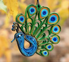 a peacock ornament hanging from a tree