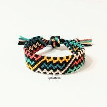 the bracelet is decorated with multicolored braids and tassels on it