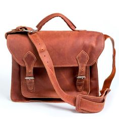 Matias Briefcase - 100% oil-tanned leather Interior design of 2 large sections and 1 small front pocket Exterior design with two buckled closures Measures 13“H x 15“W x 5“D Shoulder strap with buckle design for adjustable length of 18“ to 22” Handcrafted in Honduras This is a handmade leather item, and by nature, there wi Leather Interior Design, Leather Messenger Bag Laptop, Laptop Messenger Bags, File Folders, The Don, Leather Laptop, Be Natural, Leather Briefcase, Eco Fashion