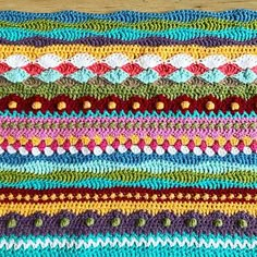 a crocheted dishcloth with multicolored stripes