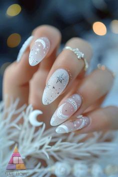 Elevate your nail game with these ethereal celestial nails. The delicate white and silver star patterns against a sheer background offer a dreamy look that's both subtle and striking. Discover more nail inspo at nailhow.com. Fancy Simple Nails, Space Themed Nails Acrylic, Summer Celestial Nails, Simple Celestial Nails, Celestial Wedding Nails, White Silver Nail Designs, White Celestial Nails, White Nail Polish Ideas, Night Court Nails