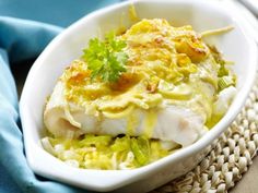 a white bowl filled with food on top of a table