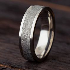 a wedding band that has been made to look like wood and silver inlays