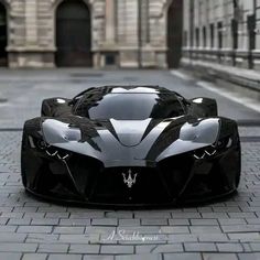 a black and white sports car parked in front of a stone building on the street