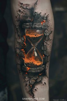 a tattoo with an hourglass on it and flames coming out of the sand inside