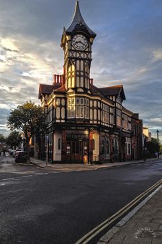 an old building with a clock tower on the corner