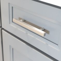 a close up view of the handles on a kitchen cabinet door with no knobs