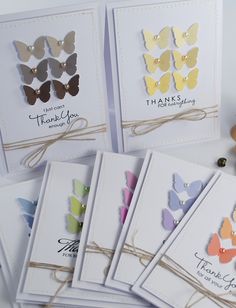 several cards with butterflies on them and some thread