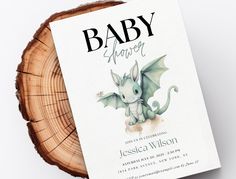 a baby shower book sitting on top of a wooden slice