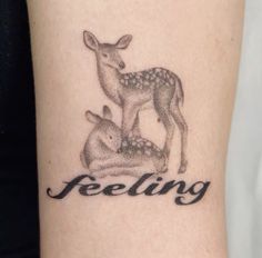 a small tattoo with the words feeling and a deer on it's arm that reads,