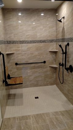 a walk in shower sitting next to a tiled floor and wall with shelves on each side