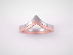 two tone gold and silver wedding band with an angled design in the middle, on a white background