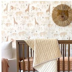 a baby crib in front of a wall with giraffes on it