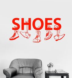 there is a wall decal that says shoes in red on the side of a room