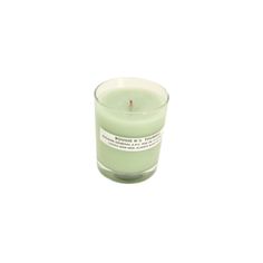 a green candle sitting on top of a white table