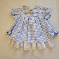 Vintage blue gingham and ruffle, toddler dress. Tagged 18 months Measures 16" shoulder to bottom hem Short Sleeve Checkered Plaid Dress With Ruffles, Blue Plaid Ruffle Dress For Spring, Blue Plaid Dress With Ruffles For Spring, Cotton Gingham Plaid Dress With Ruffles, Gingham Plaid Cotton Dress With Ruffles, Cute Ruffled Plaid Dress For Spring, Cute Gingham Dresses With Lace Trim, Spring Plaid Dress With Lace Trim, Picnic Gingham Dress With Lace Trim