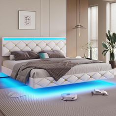 a white bed with blue lights on the bottom and headboard, in a bedroom