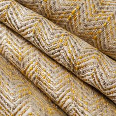 a close up shot of the texture of a knitted fabric in beige and yellow