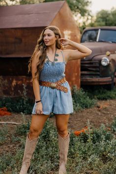 Introducing the Callista Romper - the perfect blend of comfort and style. This denim romper features a smocked bodice for a flattering fit, while the adjustable spaghetti straps and loose silhouette offer flexibility and ease. The ruffle neckline adds a touch of femininity to this western-inspired piece. Stay effortlessly chic all day long. Haylee is wearing size small paired with the Ariat Casanova Boots and Western Arrow Circle Belt Casual Spaghetti Strap Jumpsuits And Rompers With Smocked Back, Spring Denim Jumpsuits And Rompers With Adjustable Straps, Spring Medium Wash Jumpsuits And Rompers With Adjustable Straps, Summer Spaghetti Strap Jumpsuits With Elastic Waistband, Summer Jumpsuits With Spaghetti Straps And Elastic Waistband, Summer Bohemian Jumpsuits And Rompers With Smocked Back, Bohemian Summer Jumpsuits And Rompers With Smocked Back, Casual Jumpsuits With Ruffles And Spaghetti Straps, Bohemian Jumpsuits And Rompers With Smocked Bodice For Summer