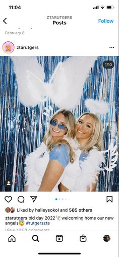 two women dressed in white and blue posing for a photo with angel wings on them