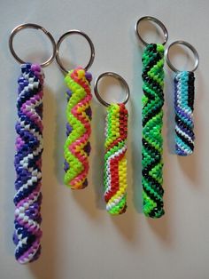 four key chains with different colors and designs on them