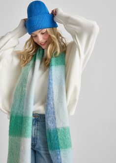 Your new go-to winter accessory. Designed super soft and oversized for layering in cold weather. Blue & green multi-colored plaid pattern.Loose twisted fringe ends.Complementary MAD HATTER logo patch.100% polyester.Hand wash cold.One size fits all.90" x 11.5" Casual Blue Scarves For Fall, Casual Blue Scarf For Fall, Trendy Blue Winter Scarves, Blue Casual Scarf For Winter, Casual Blue Scarves For Winter, Casual Blue Scarf For Winter, Casual Blue Winter Scarf, Trendy Blue Scarf For Fall, Trendy Blue Fall Hats