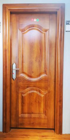 a wooden door with an electronic lock on the front and side panels, in a room