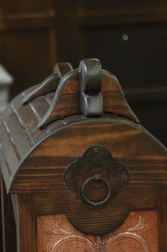 an old fashioned wooden clock with metal accents