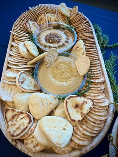 a platter filled with crackers and dip