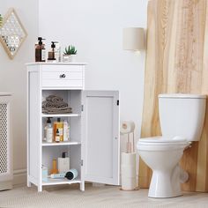 a white cabinet next to a toilet in a bathroom