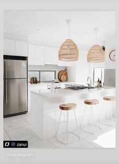 a kitchen with white counter tops and wooden stools