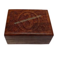 a wooden box with an intricate design on the front and sides, inlayed to it