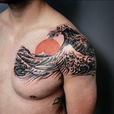 a man's chest with an orange and black wave tattoo on it