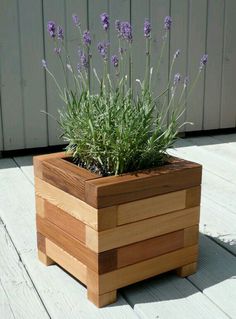 a wooden planter with lavender flowers in it