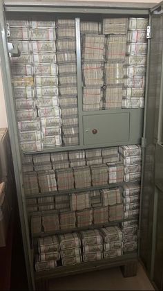 a large metal cabinet filled with lots of papers next to a wall full of files