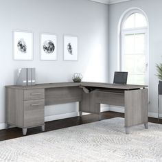 a computer desk sitting on top of a white rug