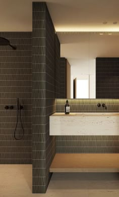 a bathroom with two sinks and a large mirror in it's center, surrounded by tiled walls