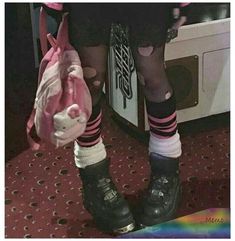 a person wearing black boots and pink socks